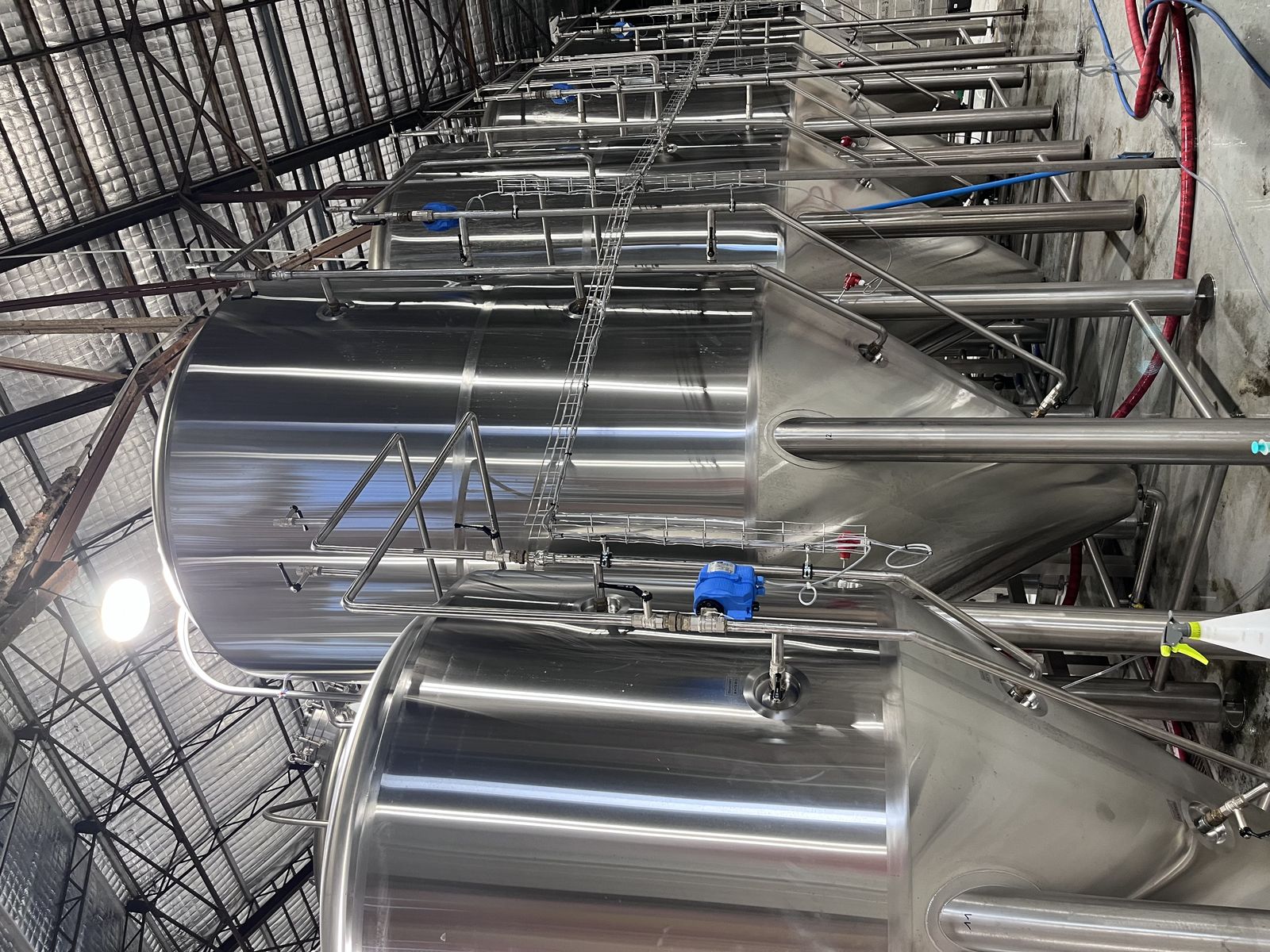 Stainless steel vats in a modern brewery